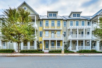 a row of multi-colored three story townhomes