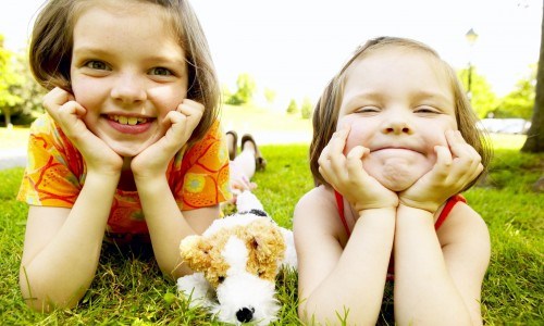 two-girls-laying-in-grass.jpg